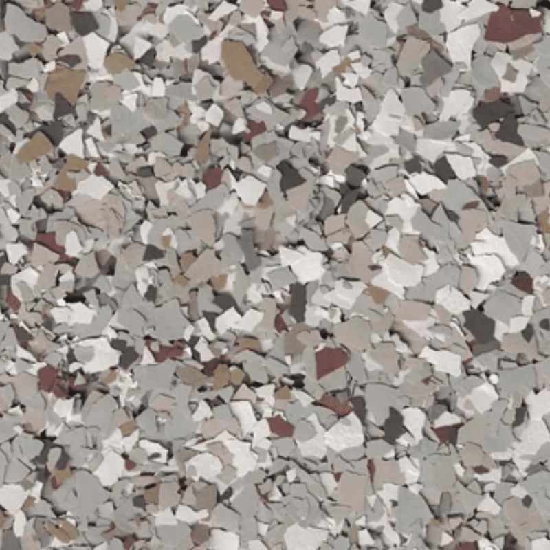 This image shows a close-up of a speckled, multi-colored surface with grey, white, brown, and black flakes, resembling a terrazzo or epoxy floor.