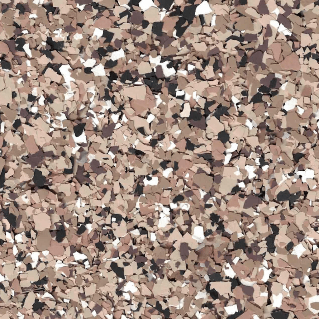 This image shows a surface covered with an abstract pattern of scattered tan, black, white, and brown flakes creating a textured appearance.